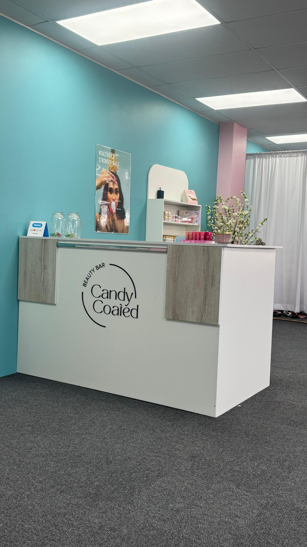 The Candy Coated Beauty Bar reception desk with the brand logo